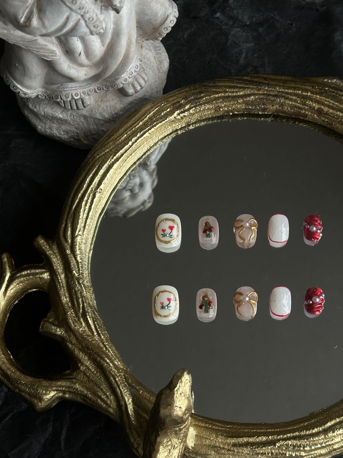 christmas themed presson nails with gold bows, chrismas trees and snowflake