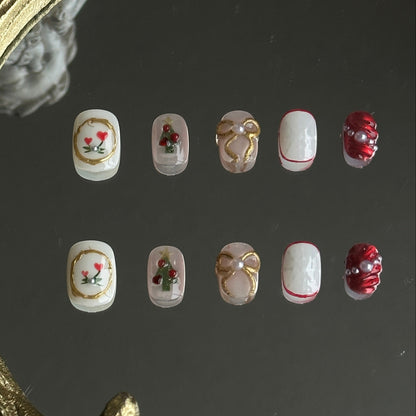 christmas themed presson nails with gold bows, chrismas trees and snowflake