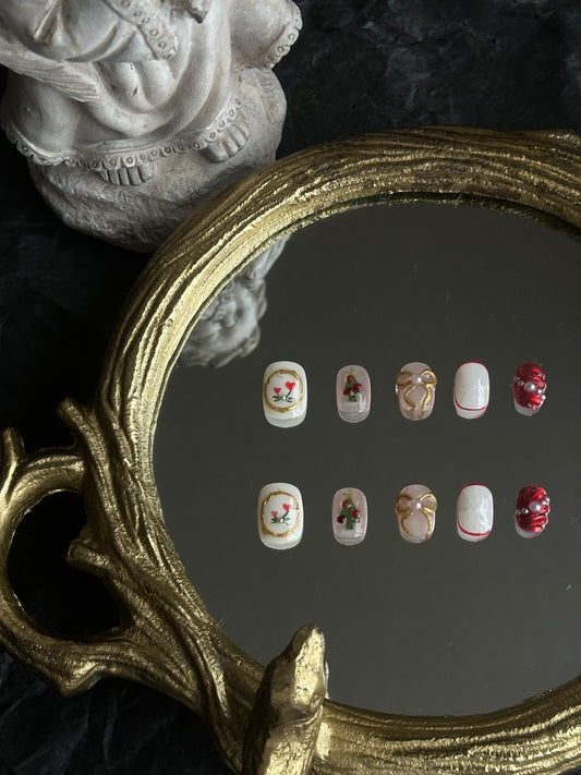 christmas themed presson nails with gold bows, chrismas trees and snowflake