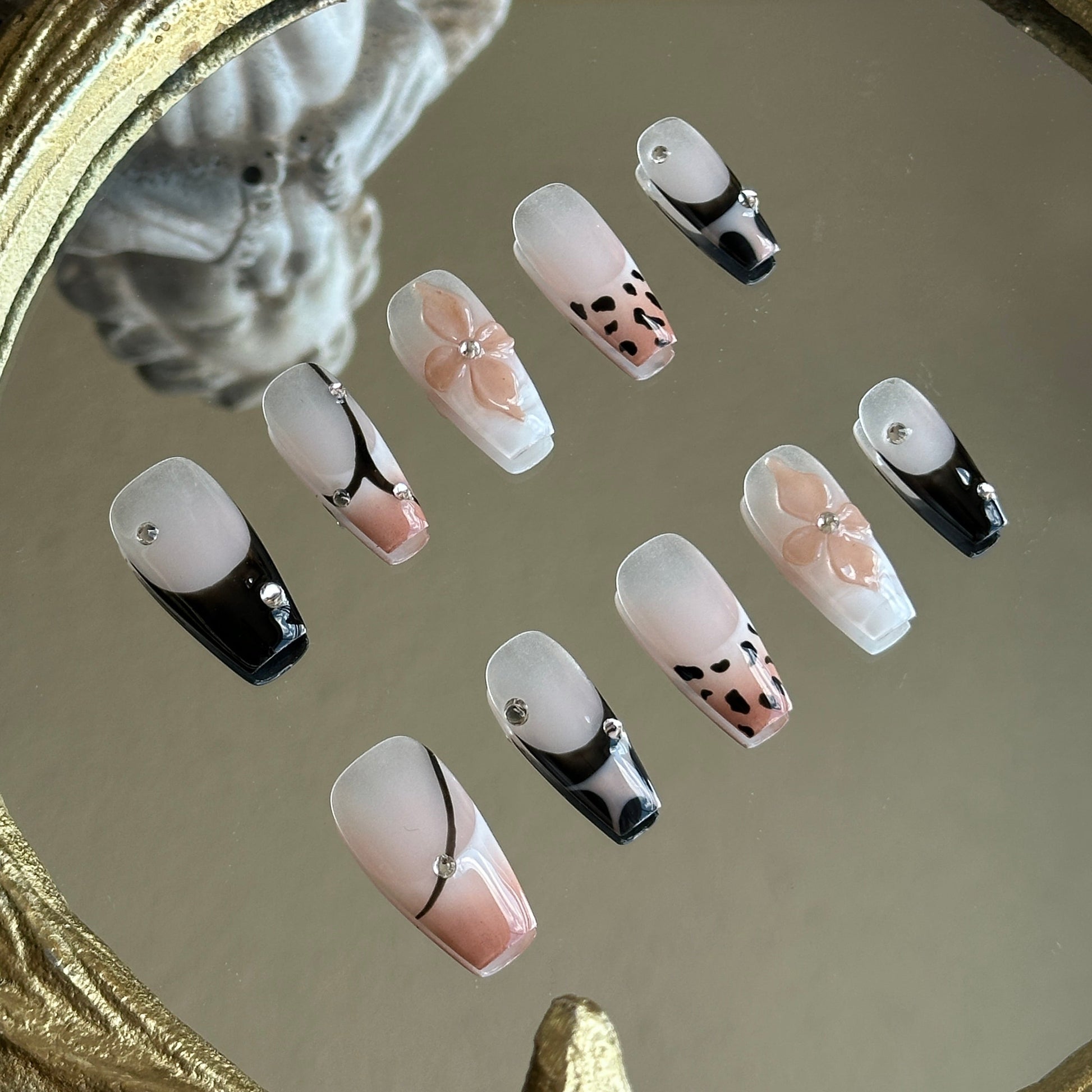Right side view of Mocha Swirl nails by MYOB Nails showing the intricate 3D nude flower charm and delicate crystal embellishments.