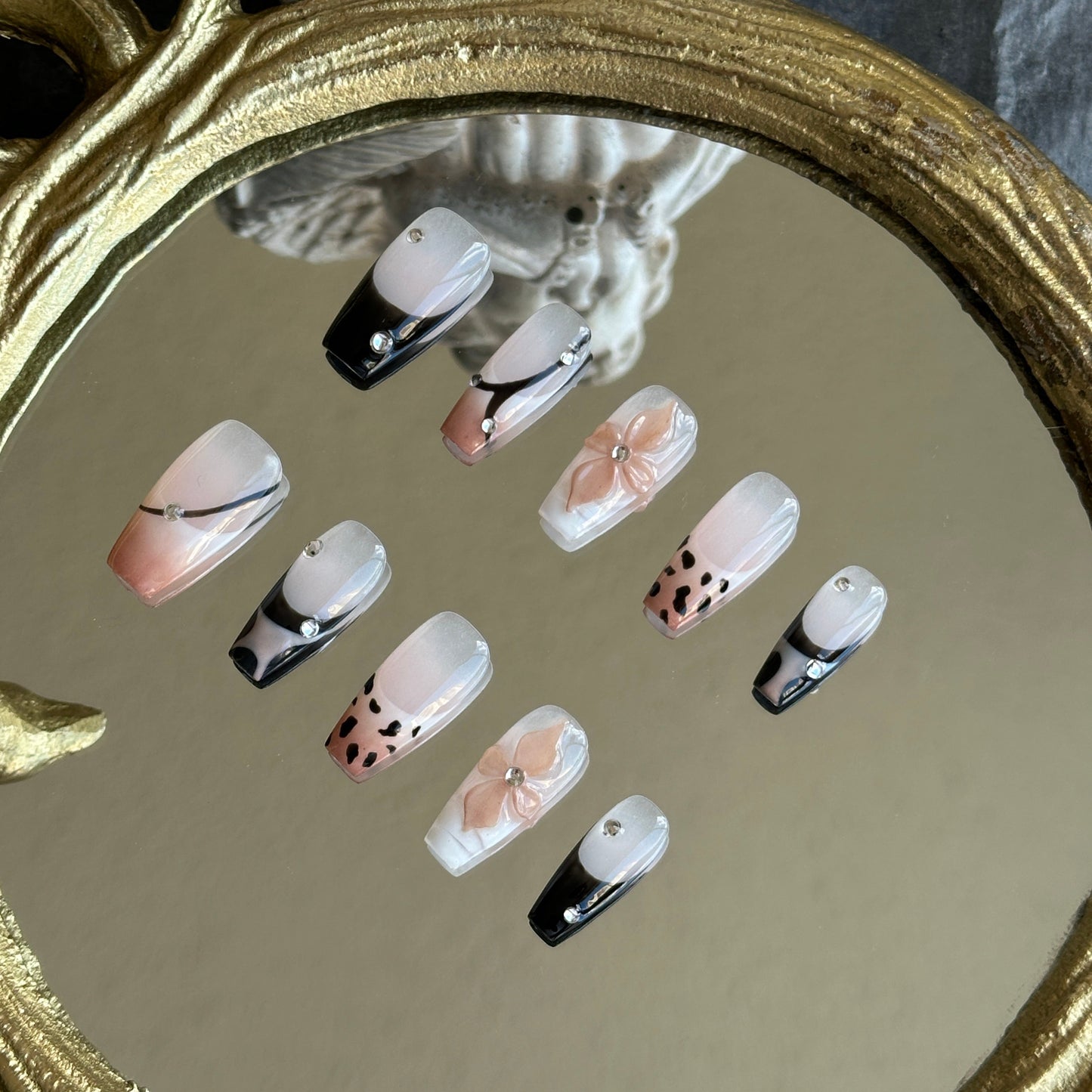 Left side detail of MYOB Nails Mocha Swirl set highlighting the hand-painted leopard print and soft nude-to-black gradient.