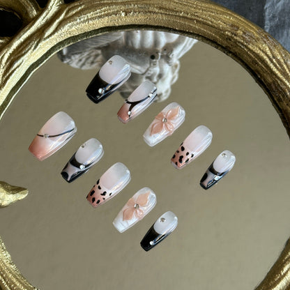 Left side detail of MYOB Nails Mocha Swirl set highlighting the hand-painted leopard print and soft nude-to-black gradient.