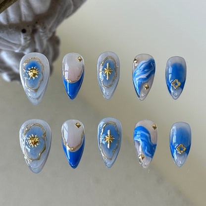 Front view of Moon River handmade nails showing the transition from nude base to blue gradient and white smudged art.