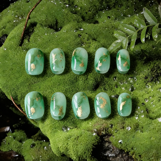 Mossy by MYOB Nails featuring forest green marble gradients and gold foil on a sheer white base.