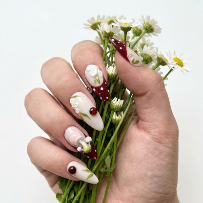 Close-up of MYOB Nails A Glimpse of the Forest set on a hand model holding a bouquet of white daisies, showcasing intricate 3D floral and forest-themed nail art.