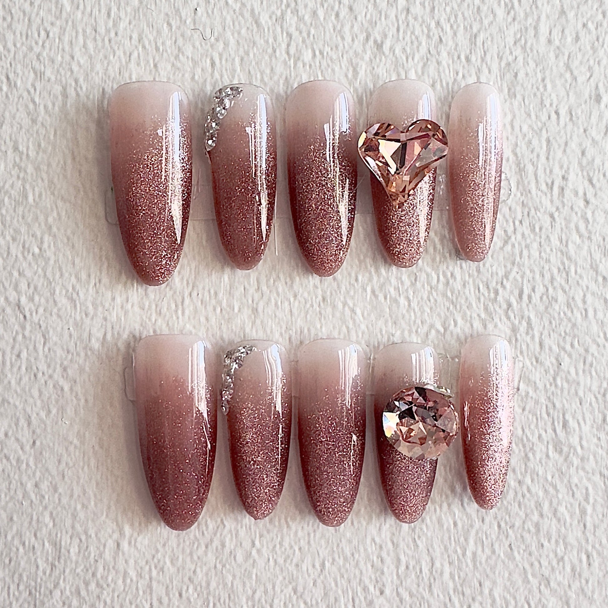 MYOB Nails elegant champagne pink glitter ombre press-on nails featuring luxury large 3D heart and round crystals with delicate sparkling accents.