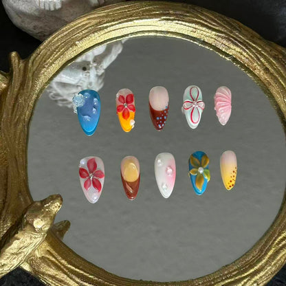 MYOB Nails Ethereal Bloom almond press-on nails, straight-on mirror flat lay, full layout of varied hand-painted floral designs, glossy nail finish and delicate gem embellishments