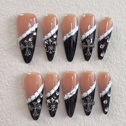 Nude and black gothic French tip nails with silver cross charms by MYOB Nails.