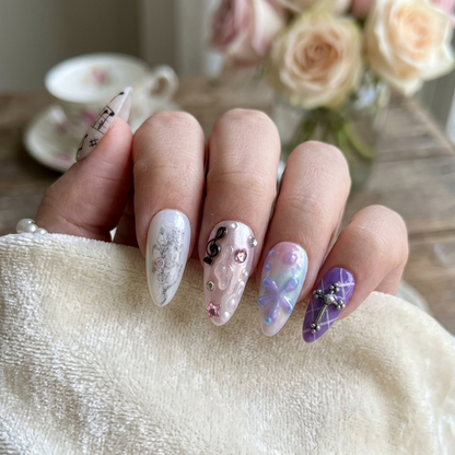 MYOB Nails Gothic Psalm press-on nails featuring a silver cross charm, 3D ribbons, and musical notes, styled with vintage roses and a tea cup for an aesthetic look.