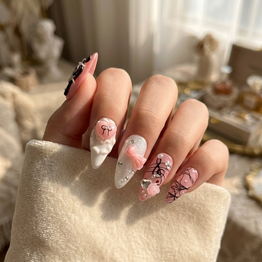 MYOB Nails Melody Muse press-on nails featuring pink and white almond shapes with 3D bows, musical notes, and delicate heart charms on a hand model.