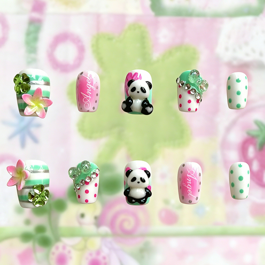 Full set of MYOB Nails Panda-monium press-on nails displayed on a cute pink background, featuring 10 pieces with 3D panda charms, floral art, and rhinestone details.
