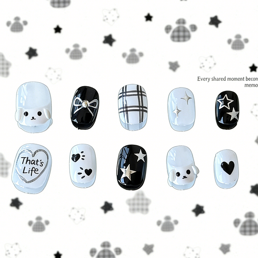 Full set of MYOB Nails PupStar press-on nails in minimalist black and white, featuring 3D puppy charms, silver "That's Life" heart art, and star doodles.