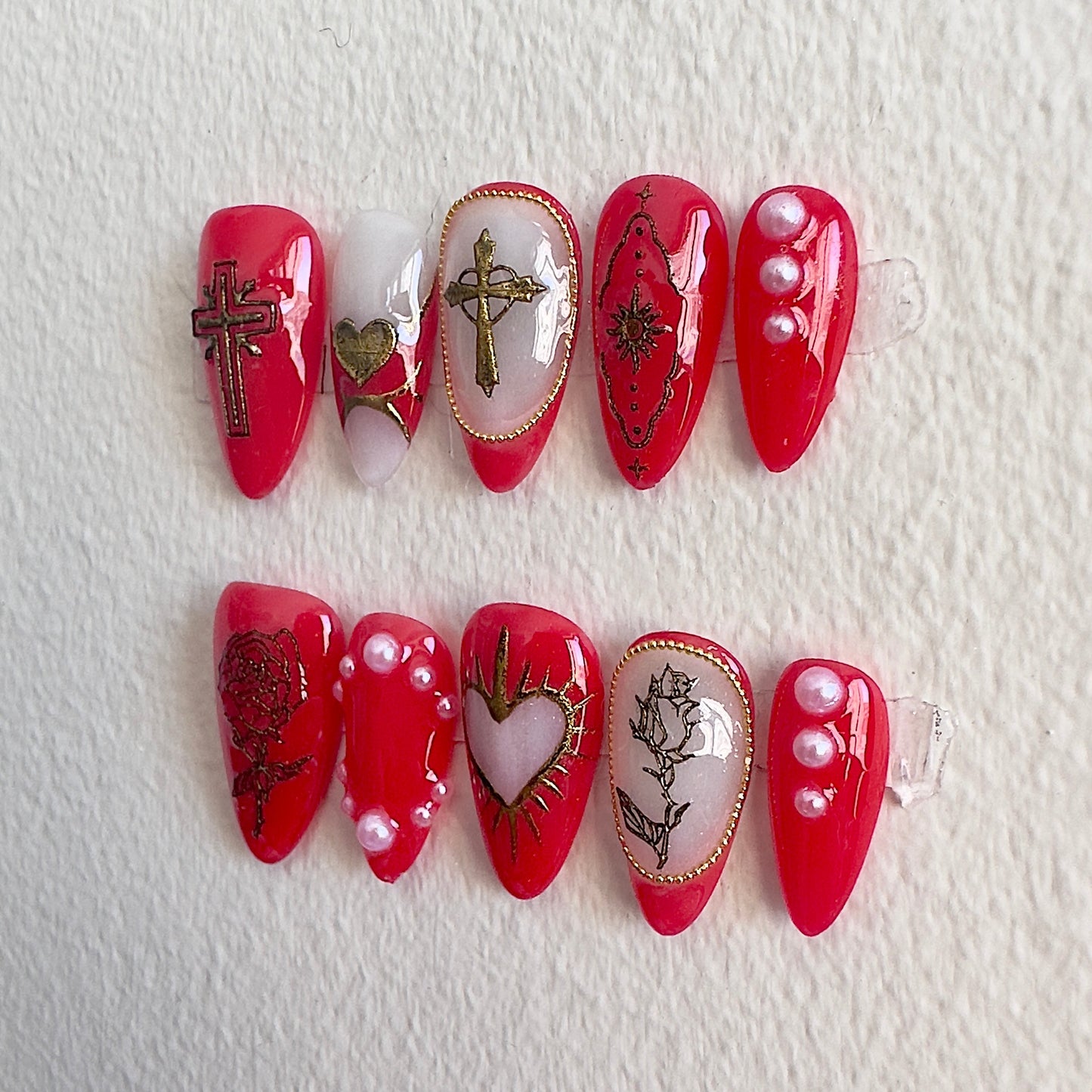 Right side view showing intricate gold rose sketches and sacred heart nail art.