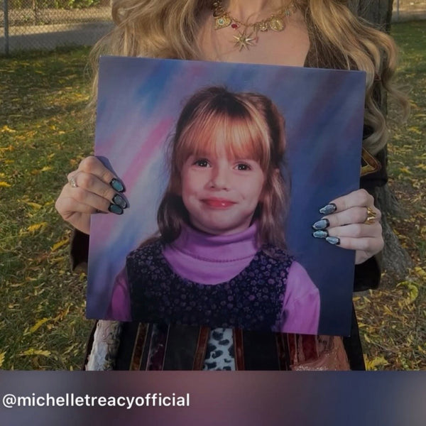 a photo from singer Michelle Treacy holding her album while wearing myobnails nail set