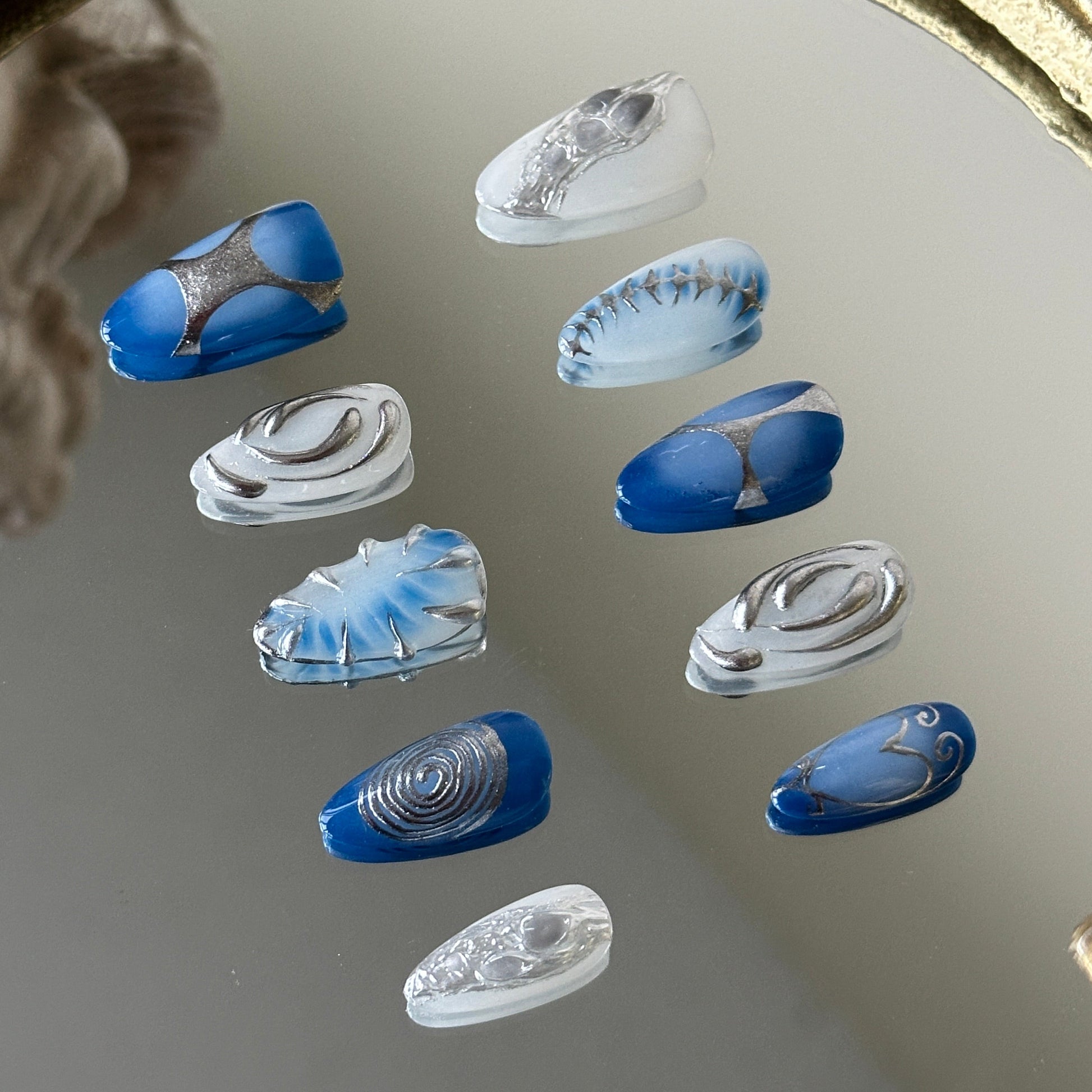 Side view highlighting the 3D silver chrome textures resembling siren scales on a sheer base.