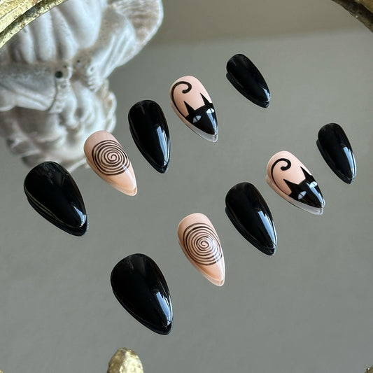 Left side detail of MYOB Nails Noir Whimsy set highlighting the intricate hand-painted black cat silhouette on a beige base.
