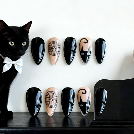Noir Whimsy press-on nails by MYOB Nails featuring a black cat with a white bowtie, showcasing the artistic cat and swirl motifs.
