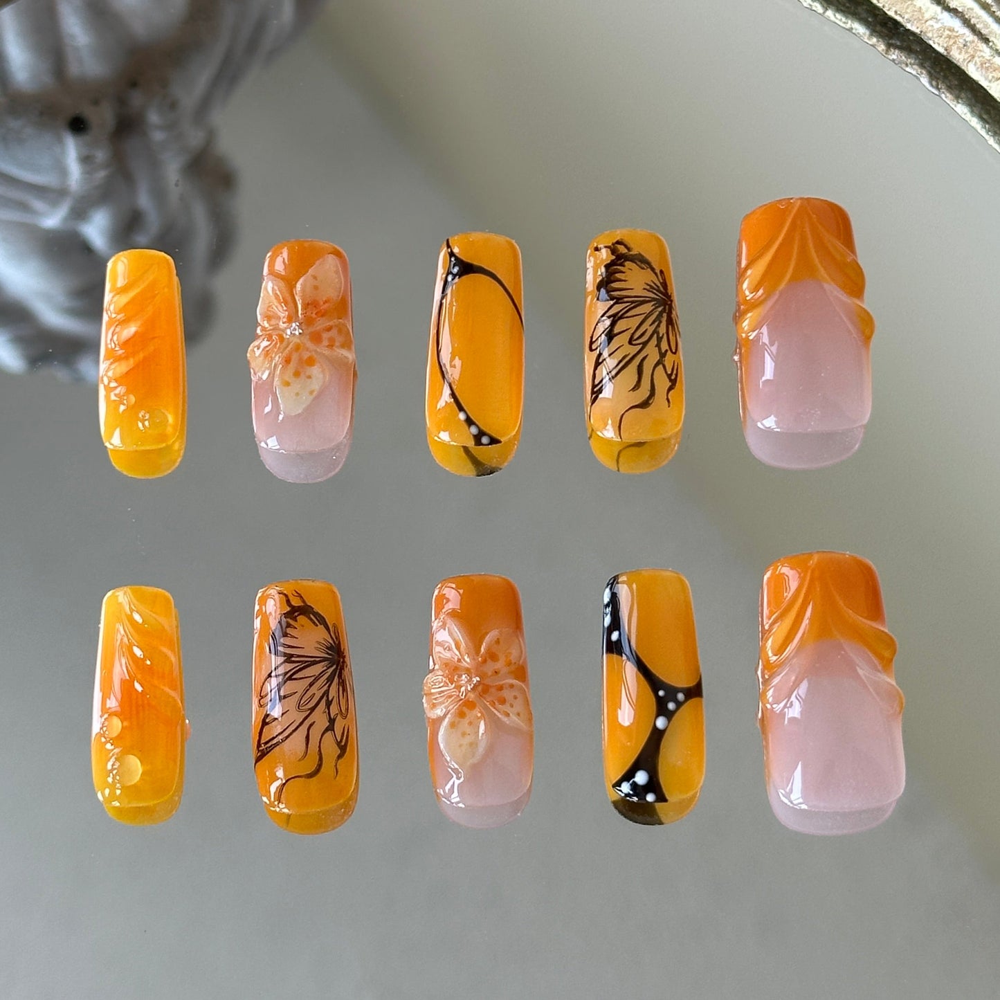 Back view highlighting the high-gloss finish and the artistic multi-layered design of the Orange Sunset set.