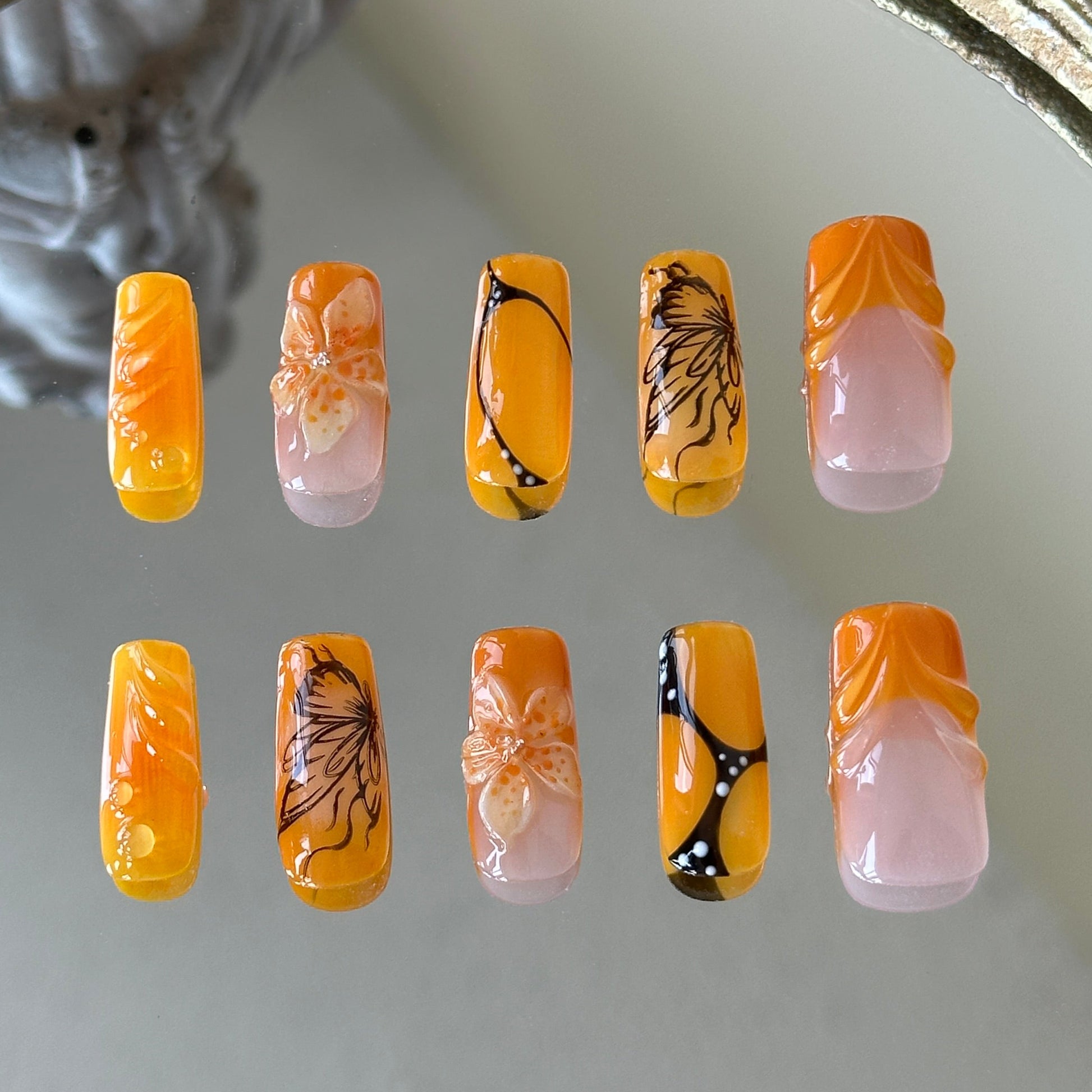 Back view highlighting the high-gloss finish and the artistic multi-layered design of the Orange Sunset set.