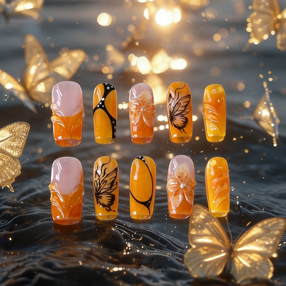 Orange Sunset nails by MYOB Nails featuring 3D flowers, butterfly wings, and white blush gradients.