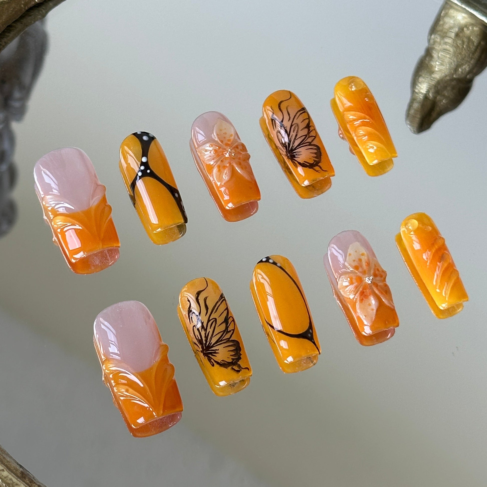 Close-up of the white center blush ombre and black-and-white dotted butterfly textures by MYOB Nails.