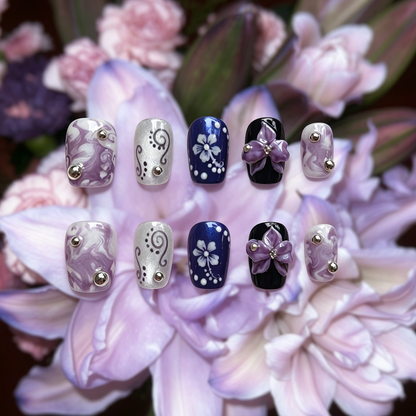 Orchid Mirage press-on nails by MYOB Nails, featuring handcrafted 3D purple orchids, intricate hibiscus sketches, and shifting aurora powder finishes.