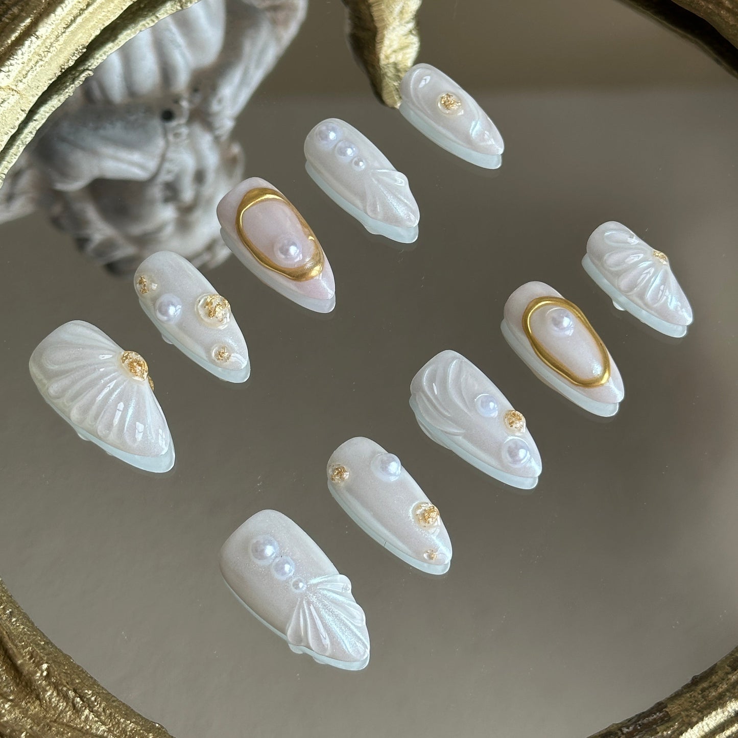 Left side detail of MYOB Nails Oyster Belle set highlighting the exquisite 3D sculpted seashell texture and aurora powder finish.