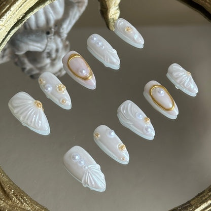 Left side detail of MYOB Nails Oyster Belle set highlighting the exquisite 3D sculpted seashell texture and aurora powder finish.