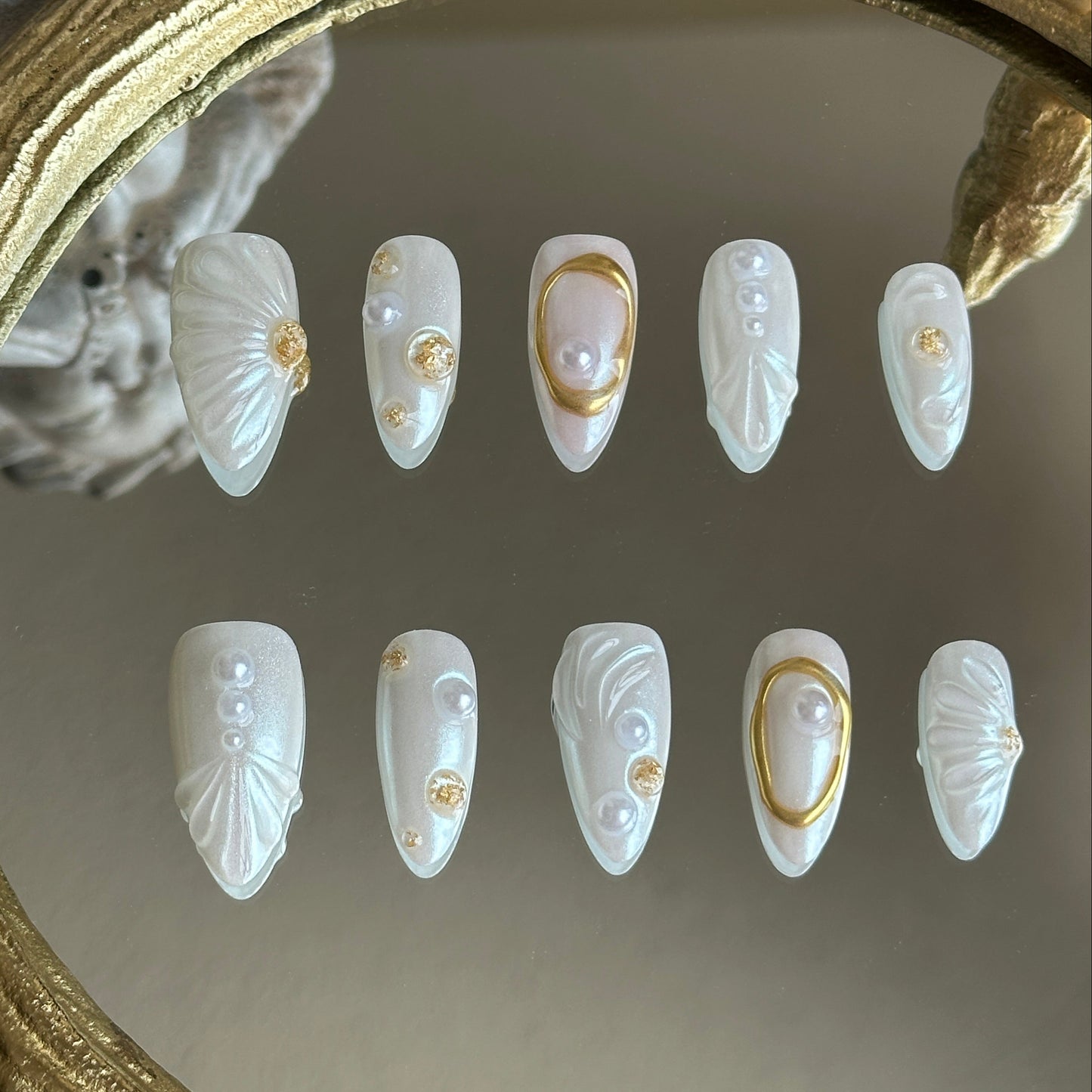 Front view of Oyster Belle handmade nails by MYOB Nails featuring iridescent shell textures and elegant 3D pearl clusters.