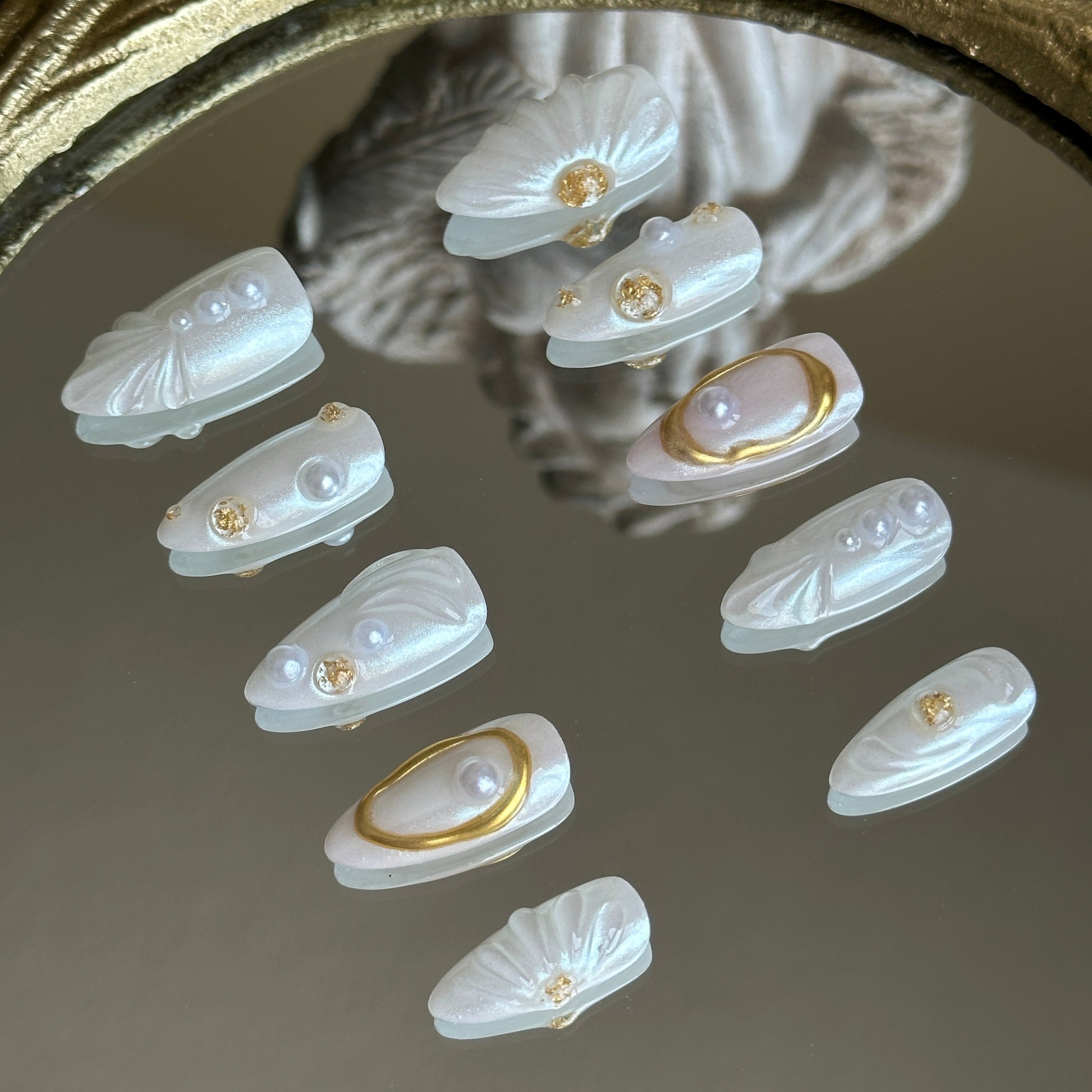 Right side view of Oyster Belle nails by MYOB Nails showing the delicate placement of pearls and holographic glitter accents.