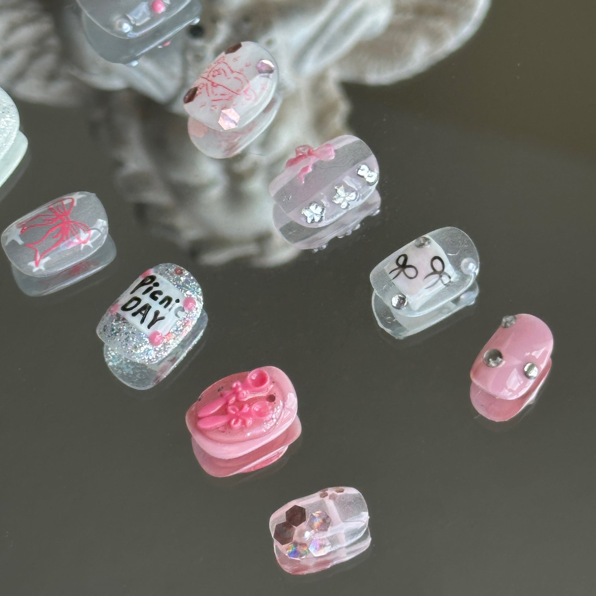 Right side view showcasing flowers made of large sequins and delicate stamped heart and bow patterns.