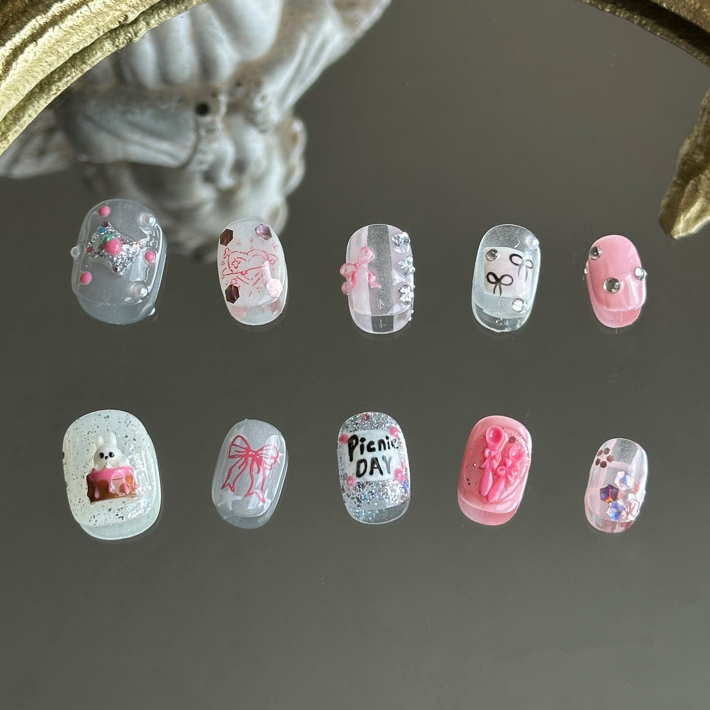 Front view of Picnic Day handmade nails showing a mix of stamped hearts, 3D candy, and hand-written 'Picnic Day' text.