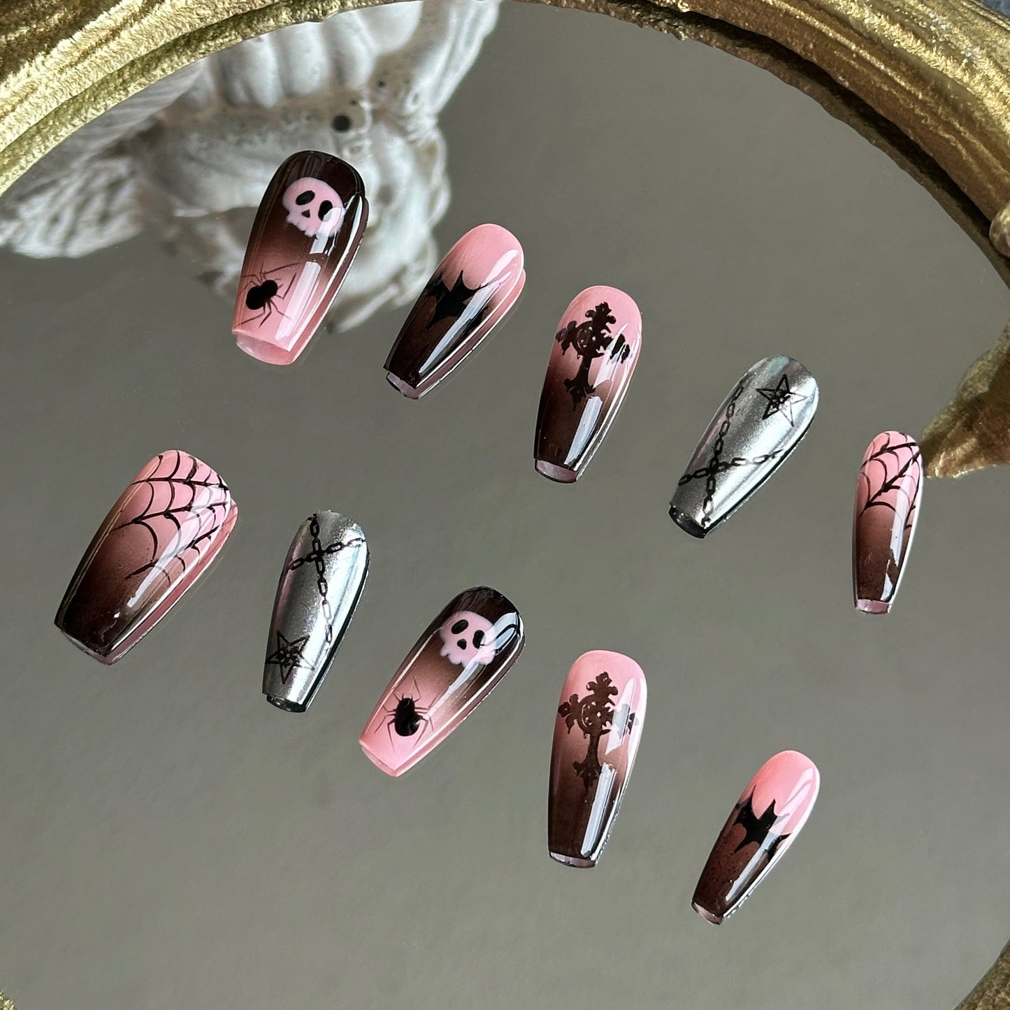 Right side view of Pink Abyss nails by MYOB Nails showing the 3D metal cross and sleek black bat silhouette silhouettes.