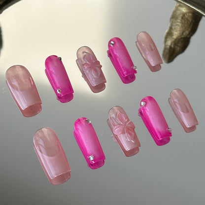 Close-up detail of the rose pink nails featuring a soft white blush gradient radiating from the center by MYOB Nails.