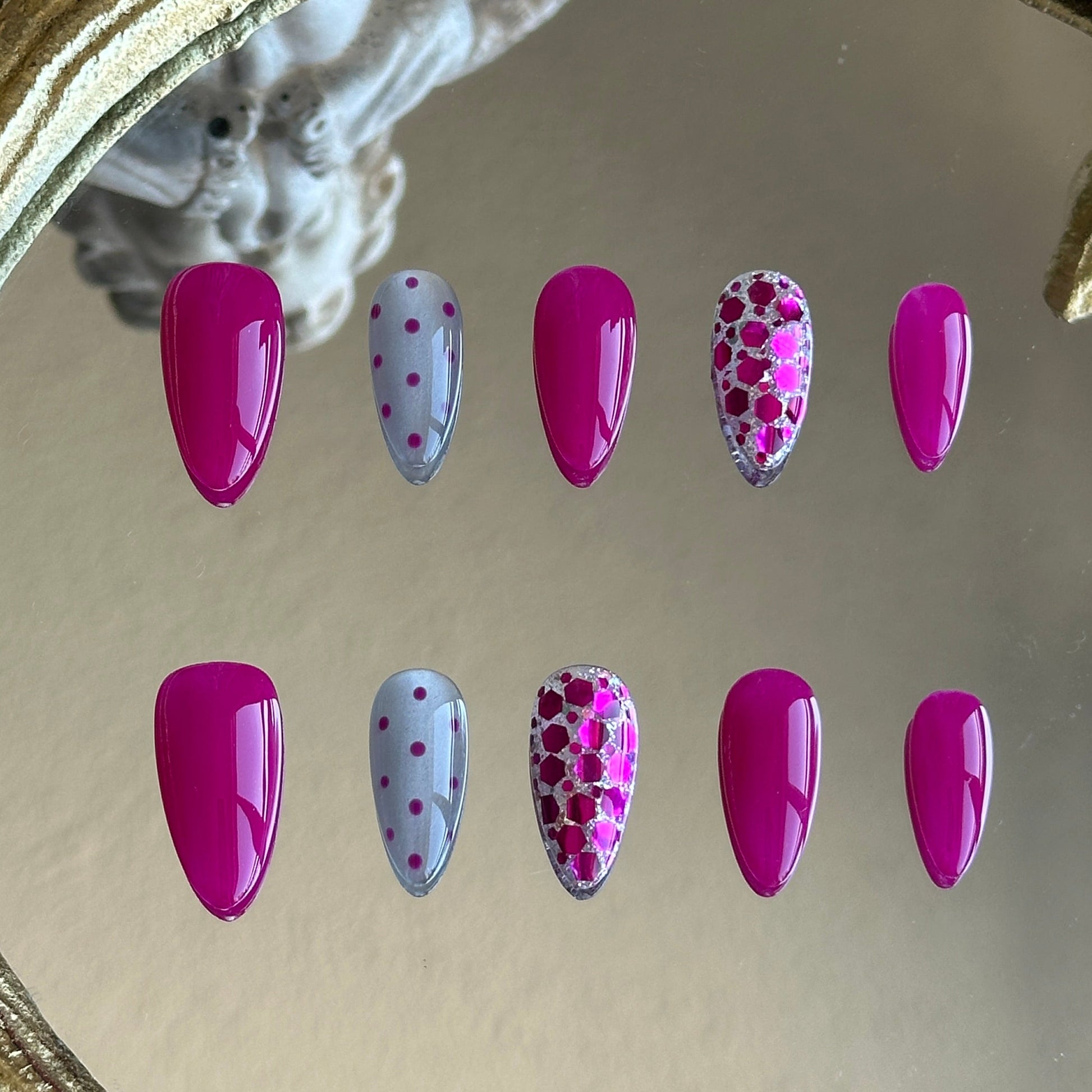 Front view of Plum Sparkle handmade nails showing the layered plum glitter and minimalist polka dot accents.