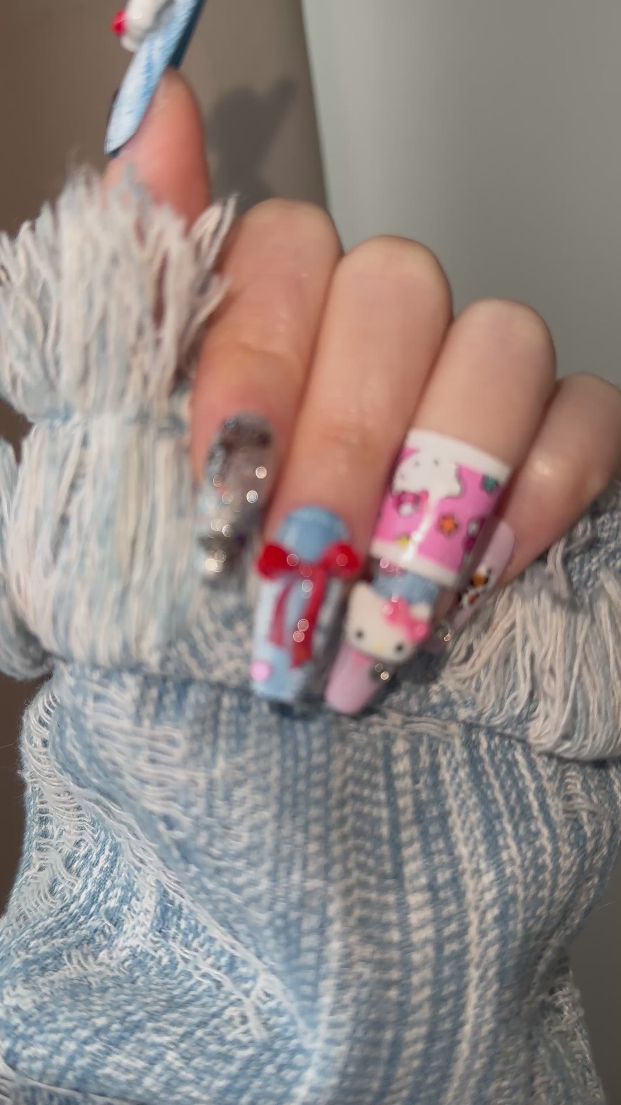 A dynamic video of a hand model showcasing the Cozy Cowgirl nails by MYOB Nails, capturing the light on the denim texture and 3D charms.