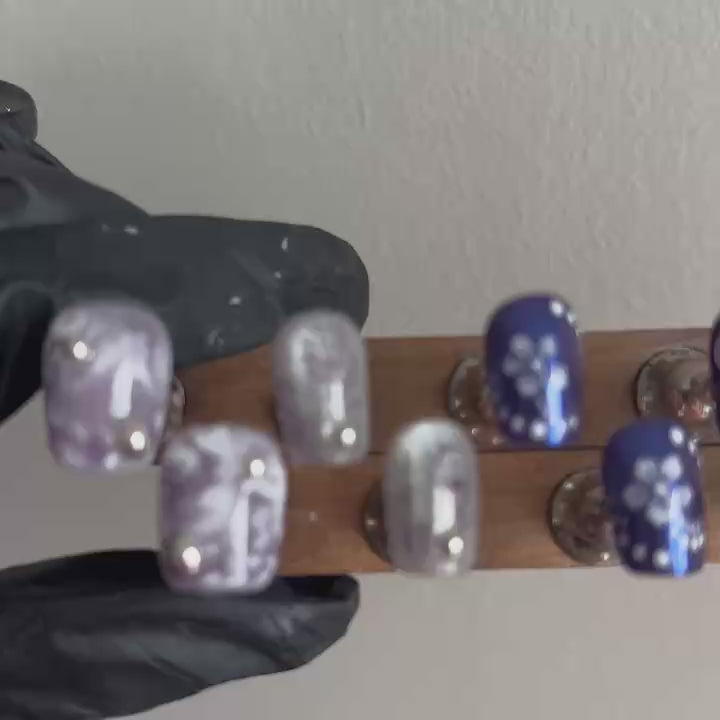 A dynamic hand-held video of MYOB Nails' Orchid Mirage, showcasing how the brilliant silver cat-eye and deep violet aurora shimmers shift under different light angles.
