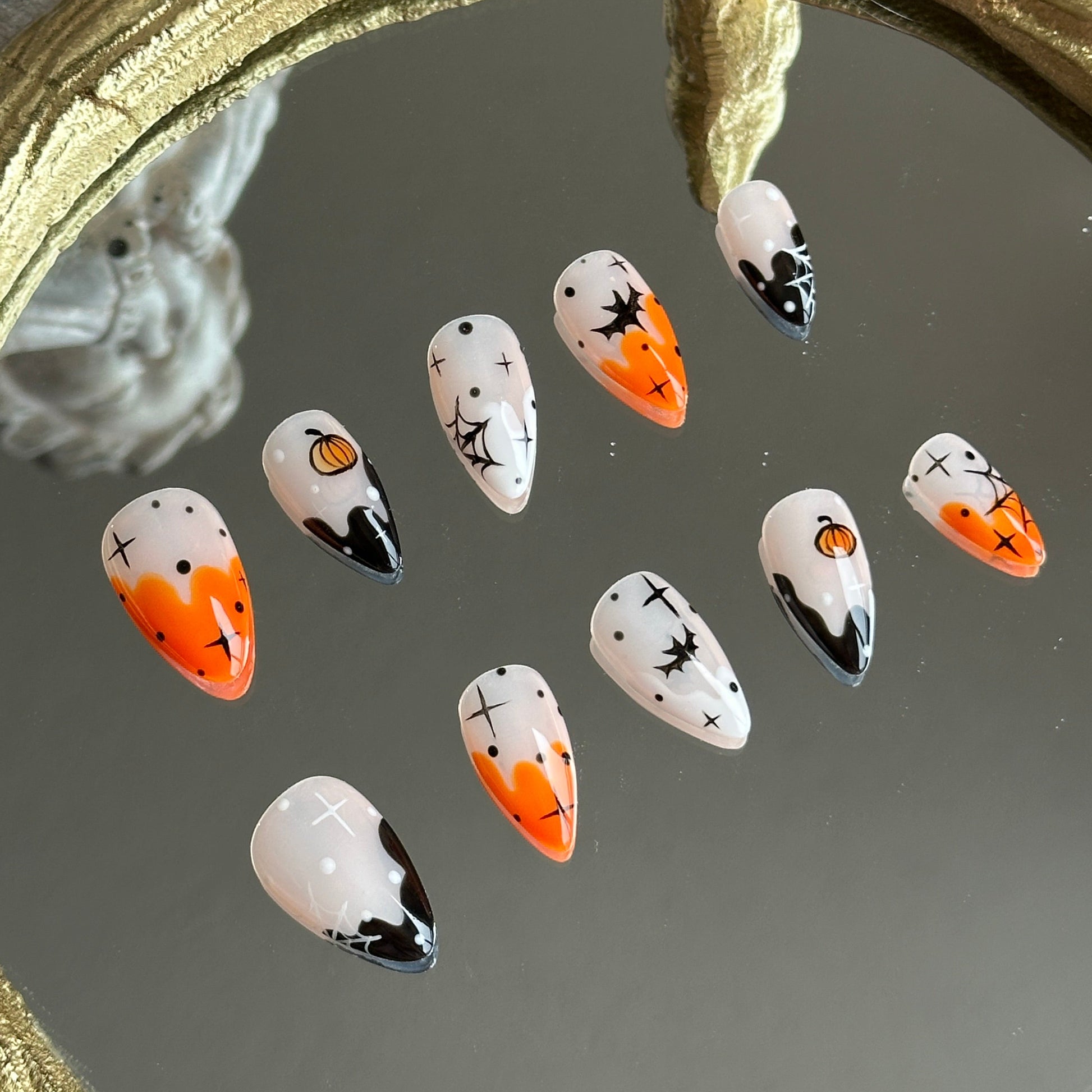 Left side detail of MYOB Nails Pumpkin Spell set highlighting the delicate hand-painted pumpkins and sparkling star motifs.