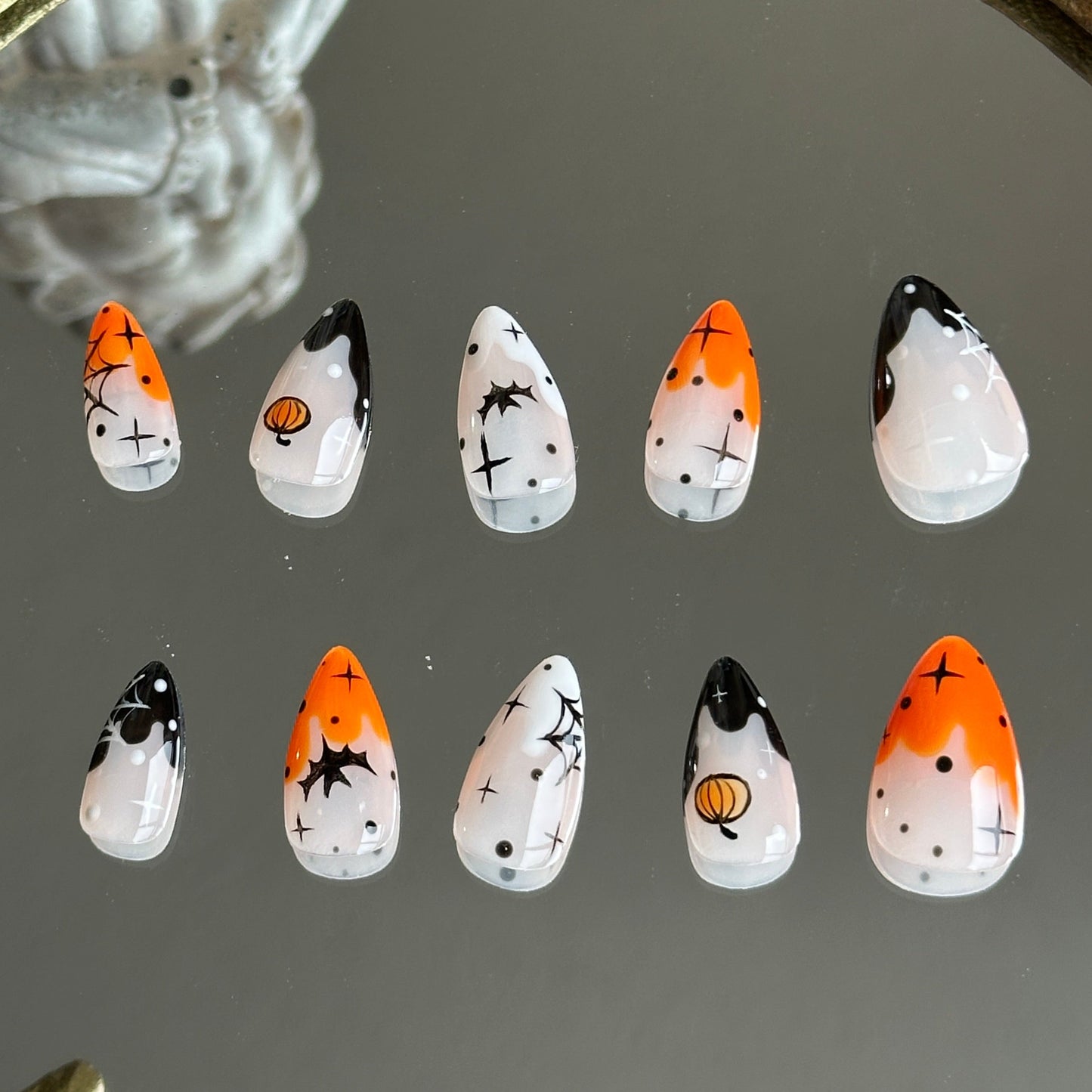 Back view of the Pumpkin Spell handcrafted nail set by MYOB Nails, showcasing a vibrant and spooky-chic aesthetic.