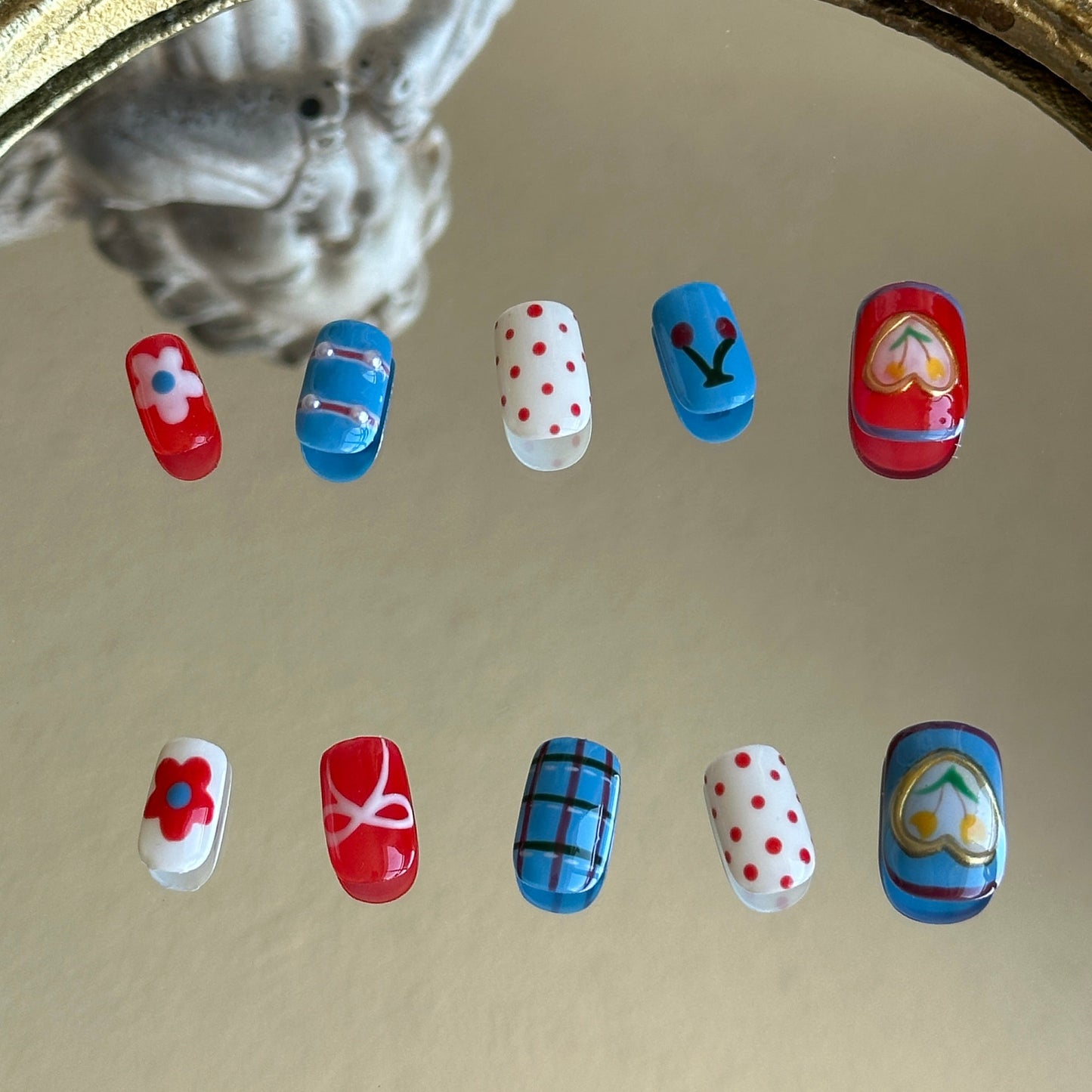 Back view of the Retro Bloom handcrafted nail set by MYOB Nails, showcasing the bold red, white, and blue tricolor aesthetic.