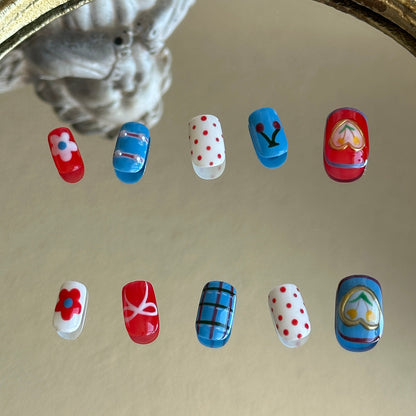 Back view of the Retro Bloom handcrafted nail set by MYOB Nails, showcasing the bold red, white, and blue tricolor aesthetic.