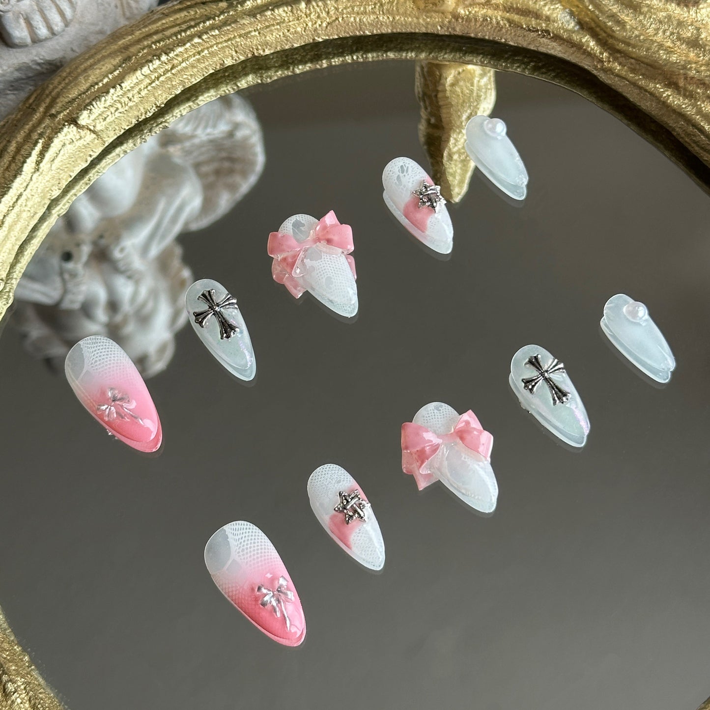 Left side detail of MYOB Nails Sacred Blush set highlighting the soft pink gradient and edgy metallic chrome cross.