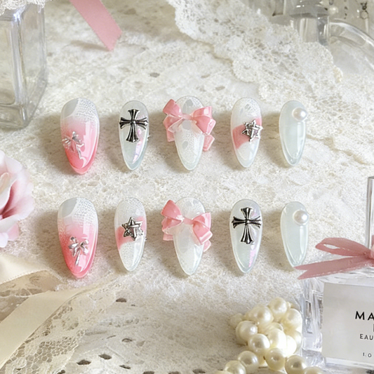 Sacred Blush press-on nails by MYOB Nails presented on a delicate white lace background with a luxury perfume bottle.