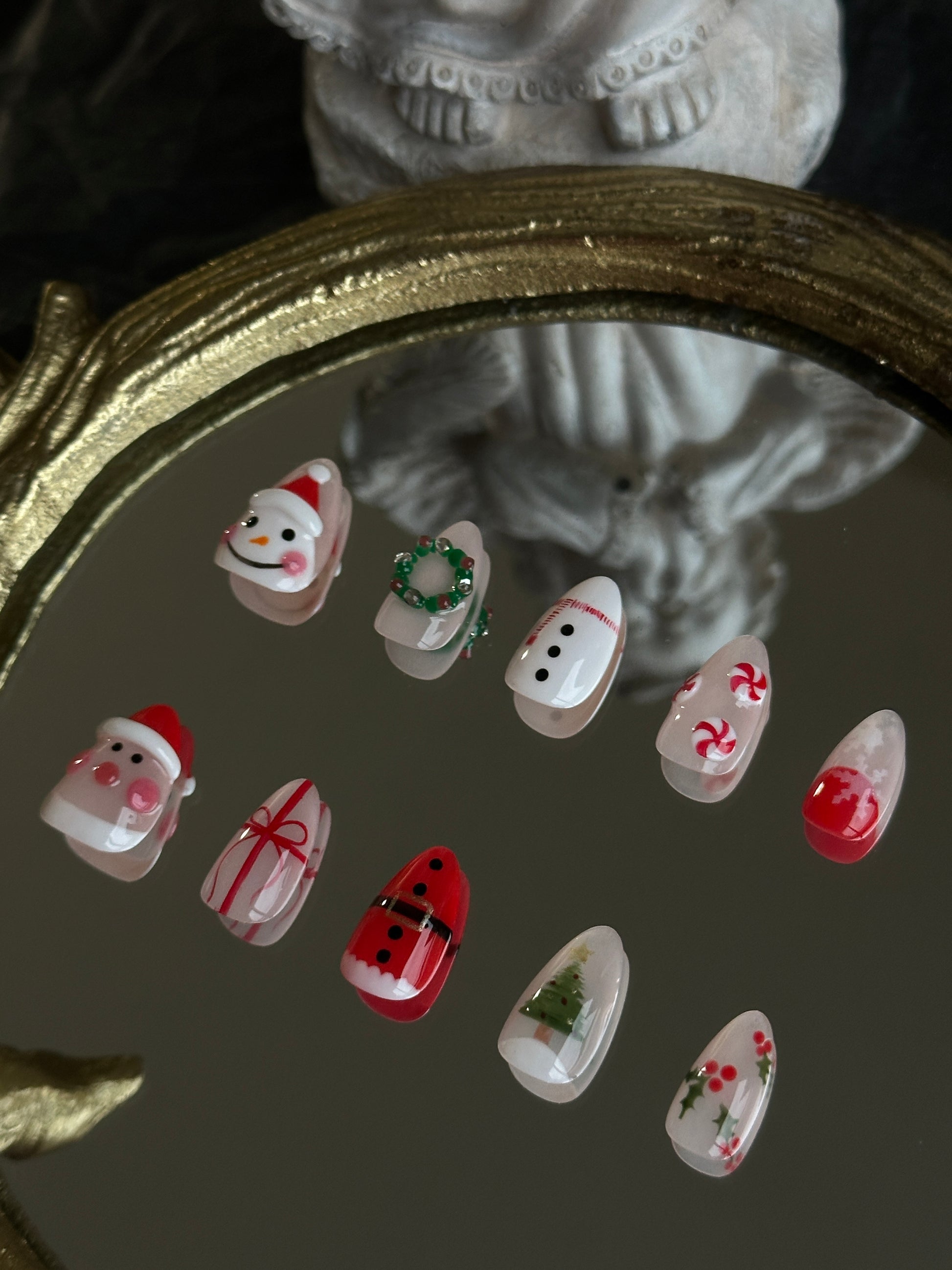 christmas themed nail set with handsculpted santa snowman, candies and wreath