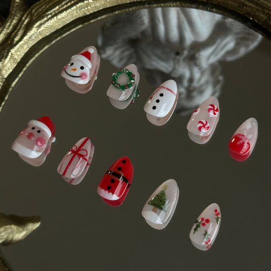 christmas themed nail set with handsculpted santa snowman, candies and wreath