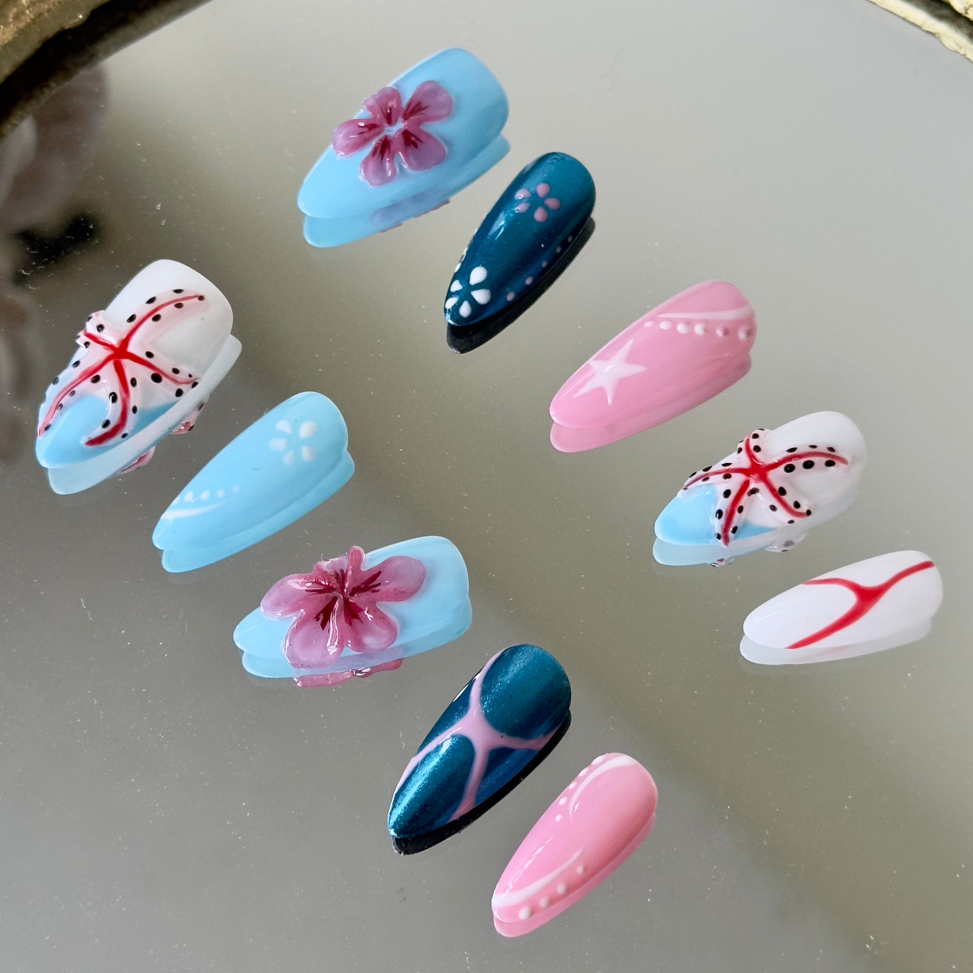 Side view highlighting the vivid 3D pink floral petals on a high-shine blue metallic chrome base.