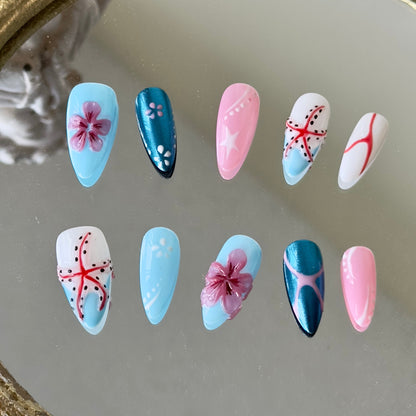 Front view of Seabloom nails showing the mix of blue French tips, pink 3D accents, and intricate linework.