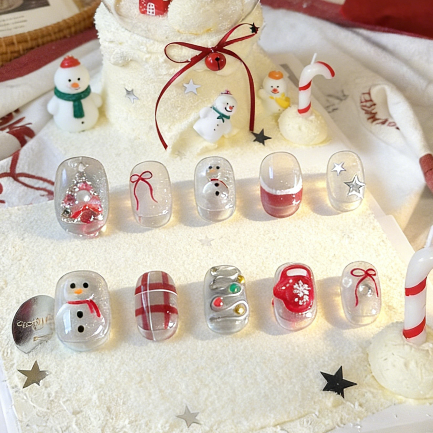 Silver Jolly press-on nails by MYOB Nails featuring cute snowman, red plaid patterns, and festive holiday designs.