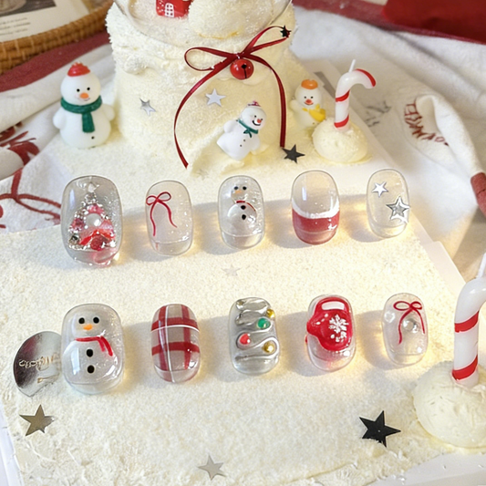 Silver Jolly press-on nails by MYOB Nails featuring cute snowman, red plaid patterns, and festive holiday designs.