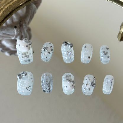 Front view of Silver Kitty handmade nails showing silver chrome stars, hearts, and delicate pearl accents.